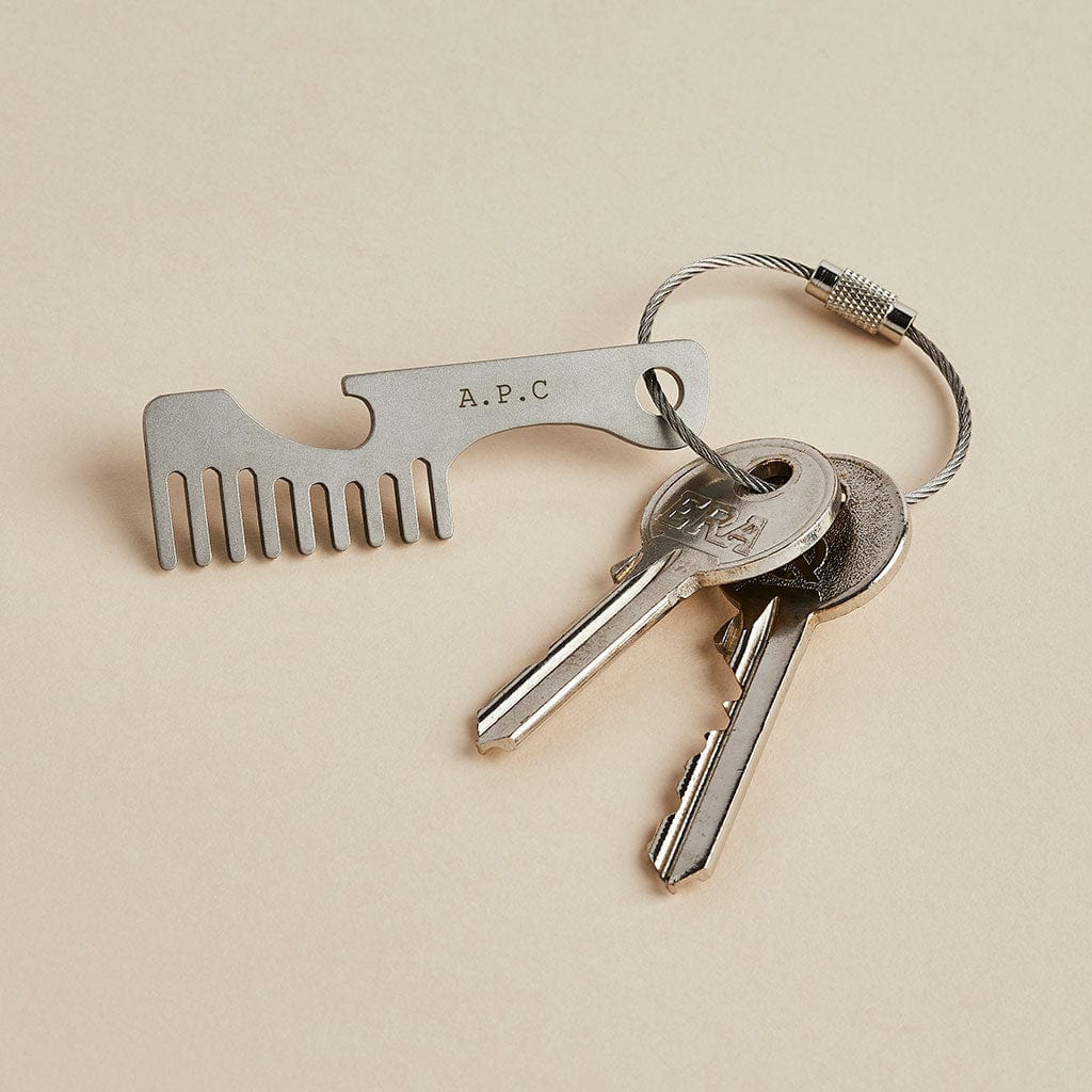 Steel moustache comb with built in bottle opener, attached to a set of keys