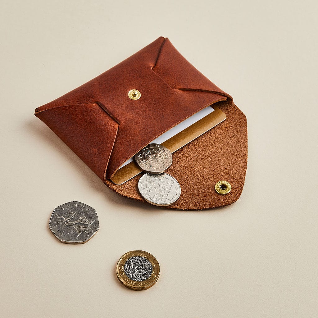 Brown leather coin pouch by Man & Bear, shown open with cards and coins