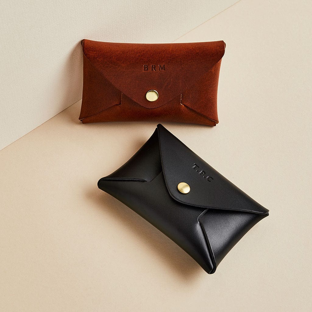 Brown and black leather coin pouches by Man & Bear with personalised initials