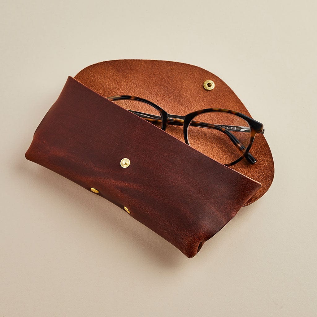Brown leather glasses case shown with men's glasses, made by Man & Bear