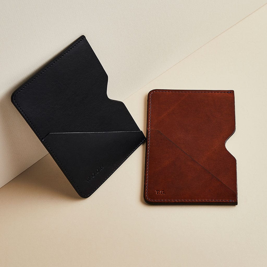 Pair of Man & Bear leather passport sleeves in black and brown