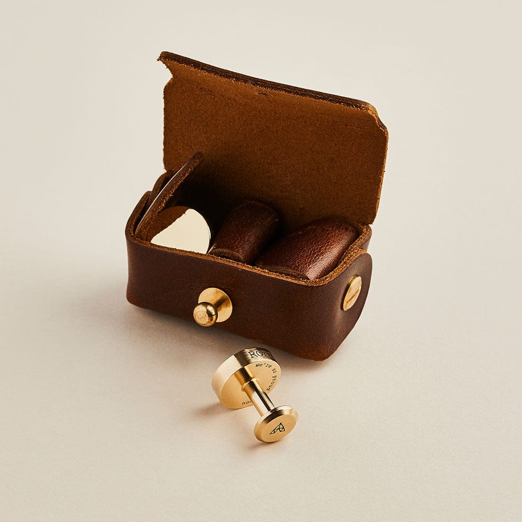 Brown leather cufflink pouch with brass Man & Bear cufflinks