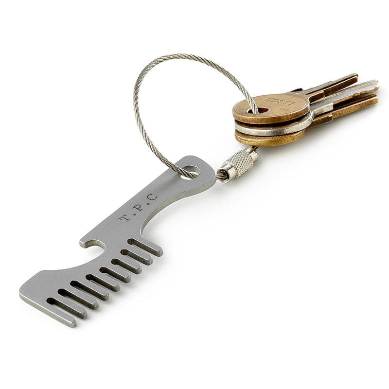 Steel moustache comb with built in bottle opener, attached to a set of keys