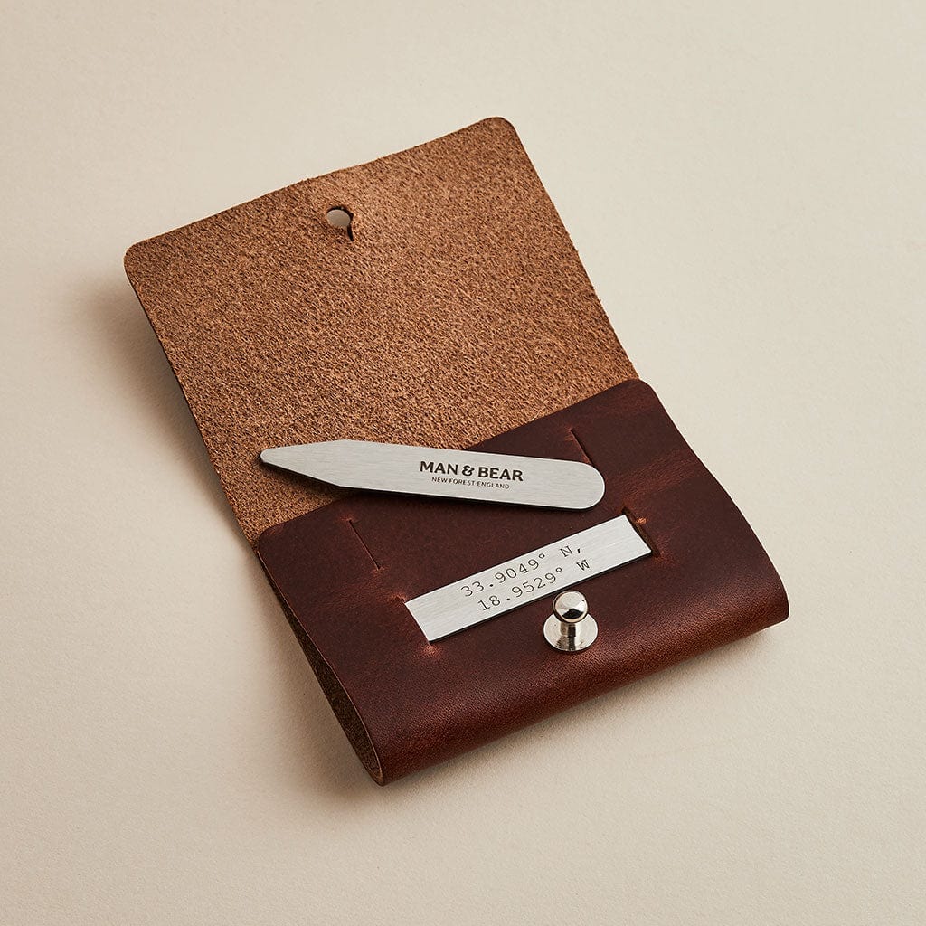 Collar stiffeners engraved with personalised coordinates and the Man & Bear logo, in a brown leather case