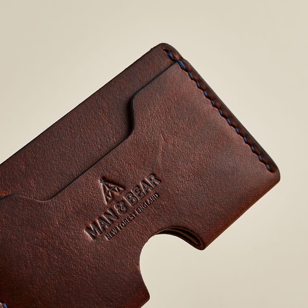 Brown leather men's card holder showing Man & Bear branding