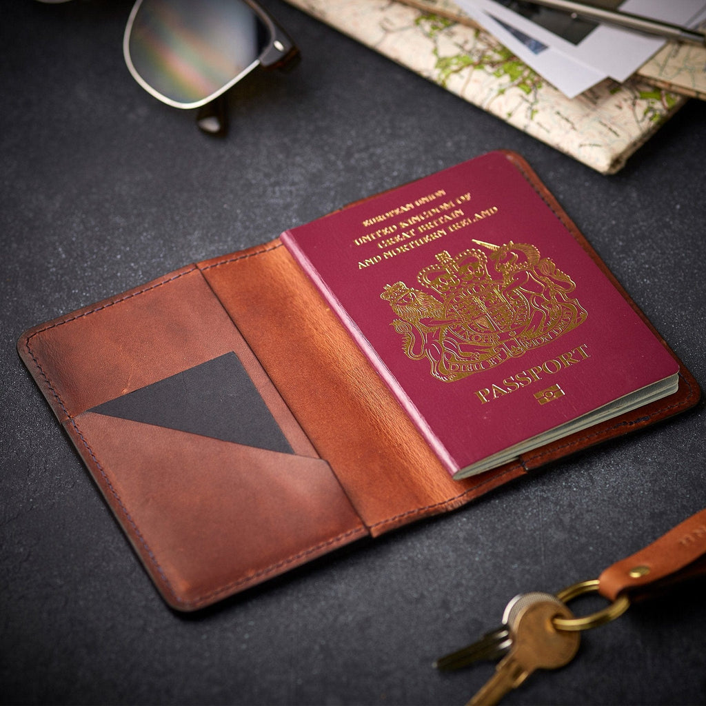 Brown leather passport holder by Man & Bear, shown with a British passport