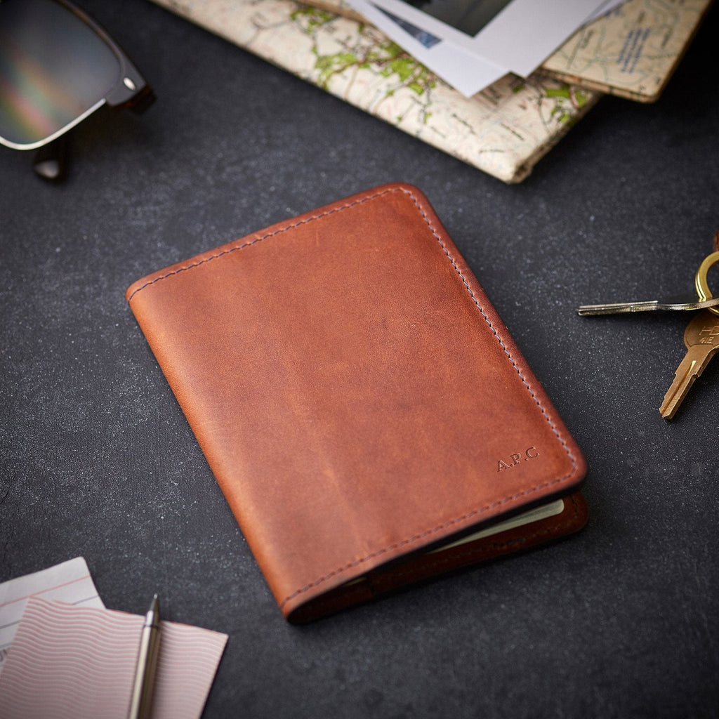 Brown leather passport holder with personalised initials, made by Man & Bear