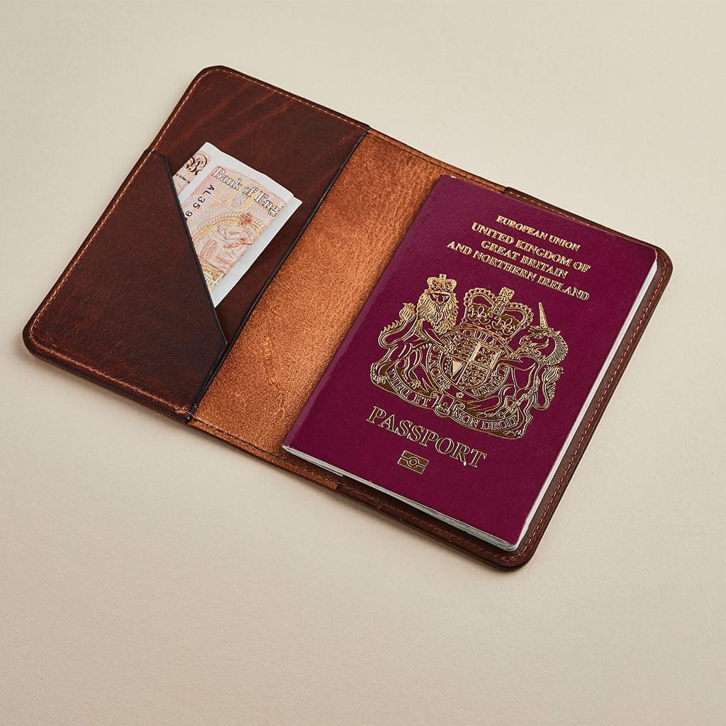 Brown leather passport holder by Man & Bear, shown with a British passport