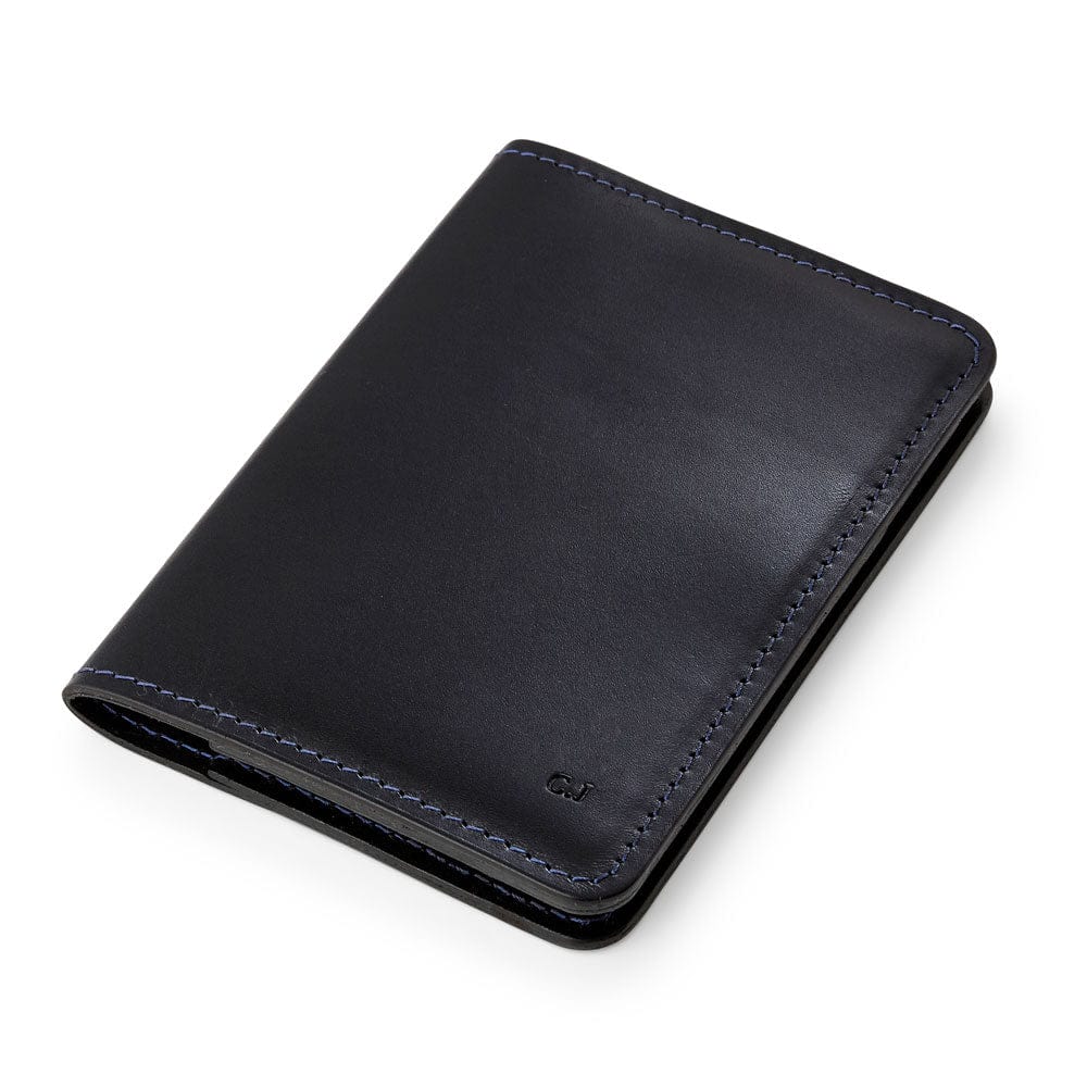 Black leather passport holder with personalised initials, made by Man & Bear