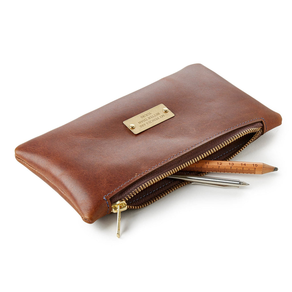 Brown leather pencil case by Man & Bear, shown with pens and pencils - cut out image
