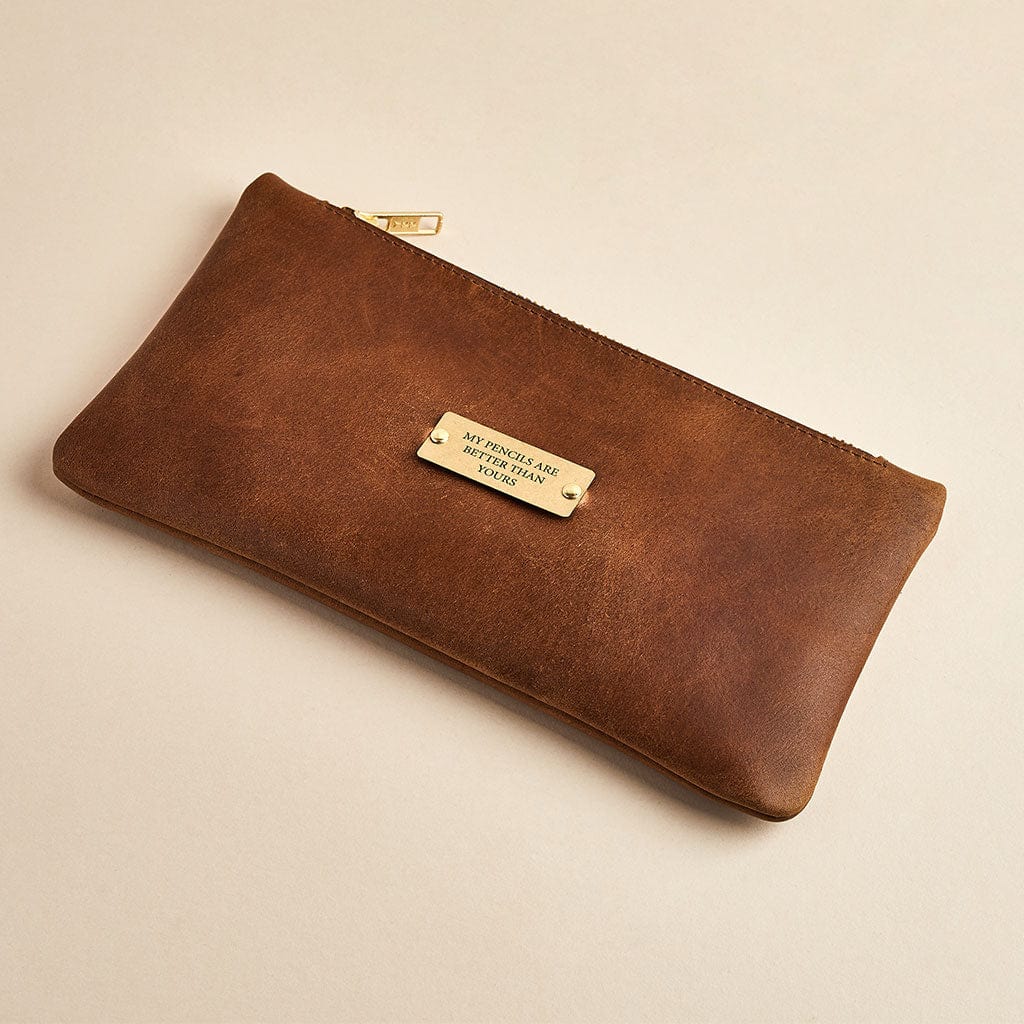 Brown leather pencil case with brass zip, engraved 'my pencils are better than yours' - made by Man & Bear