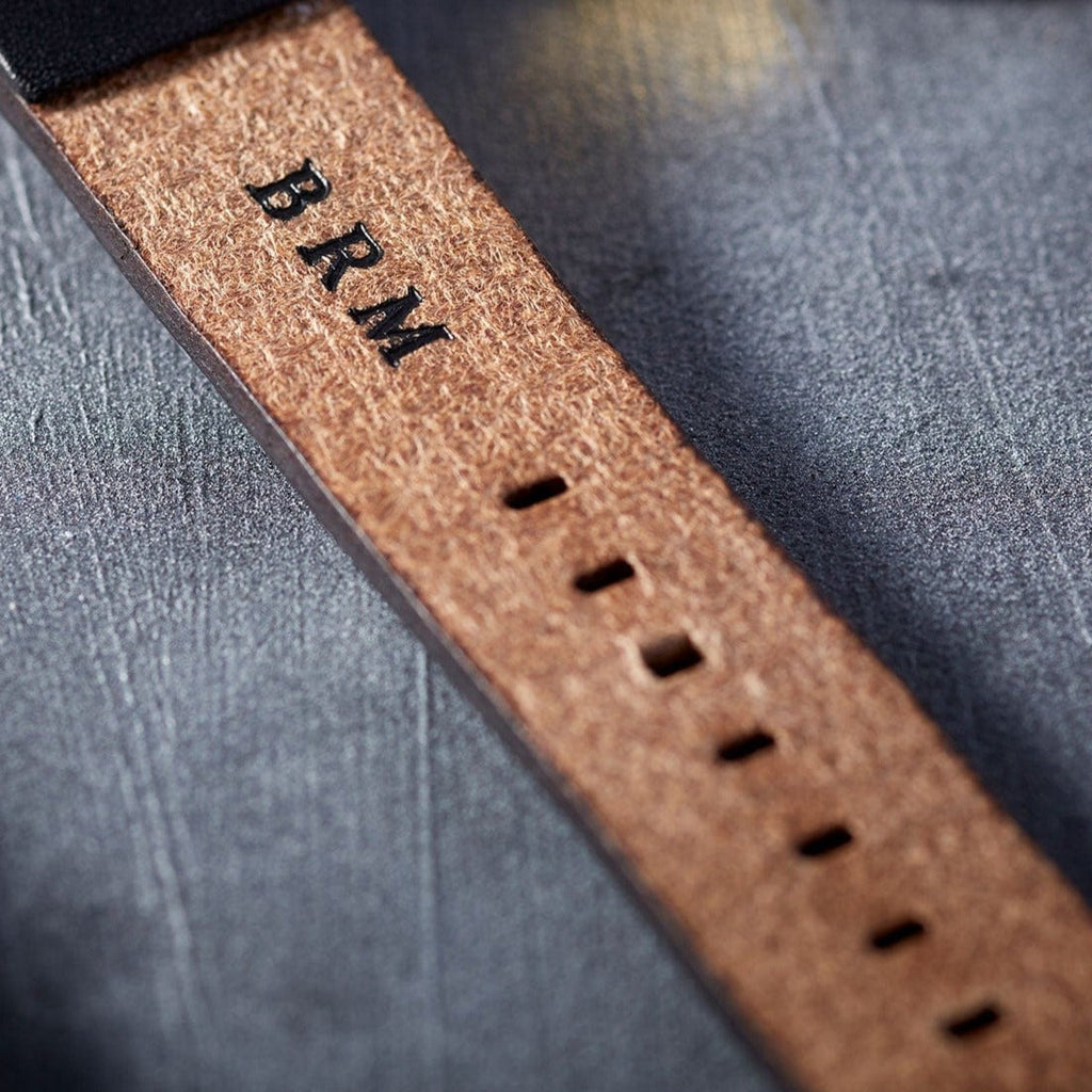 Inside of a leather watch strap personalised with initials